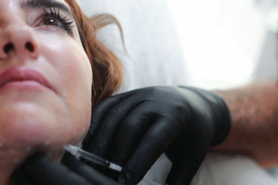 A dermal filler injection being administered in a clinic setting