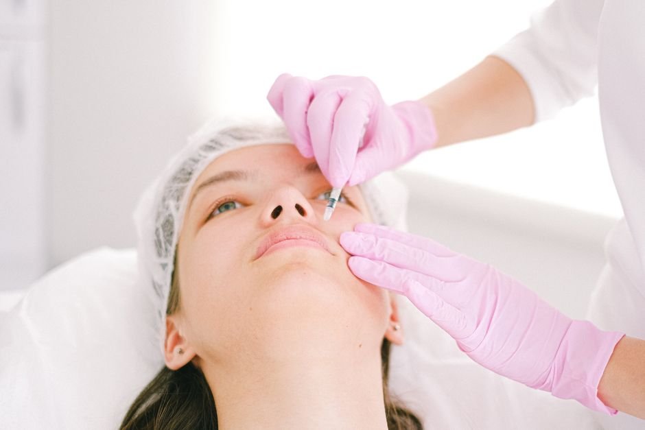 A facial injection being administered in a clinical setting