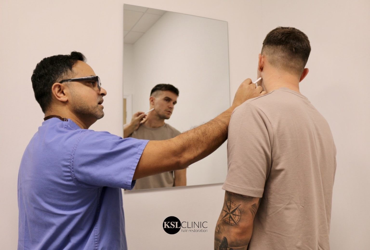 Dr Matee marking out a beard transplant design with a patient
