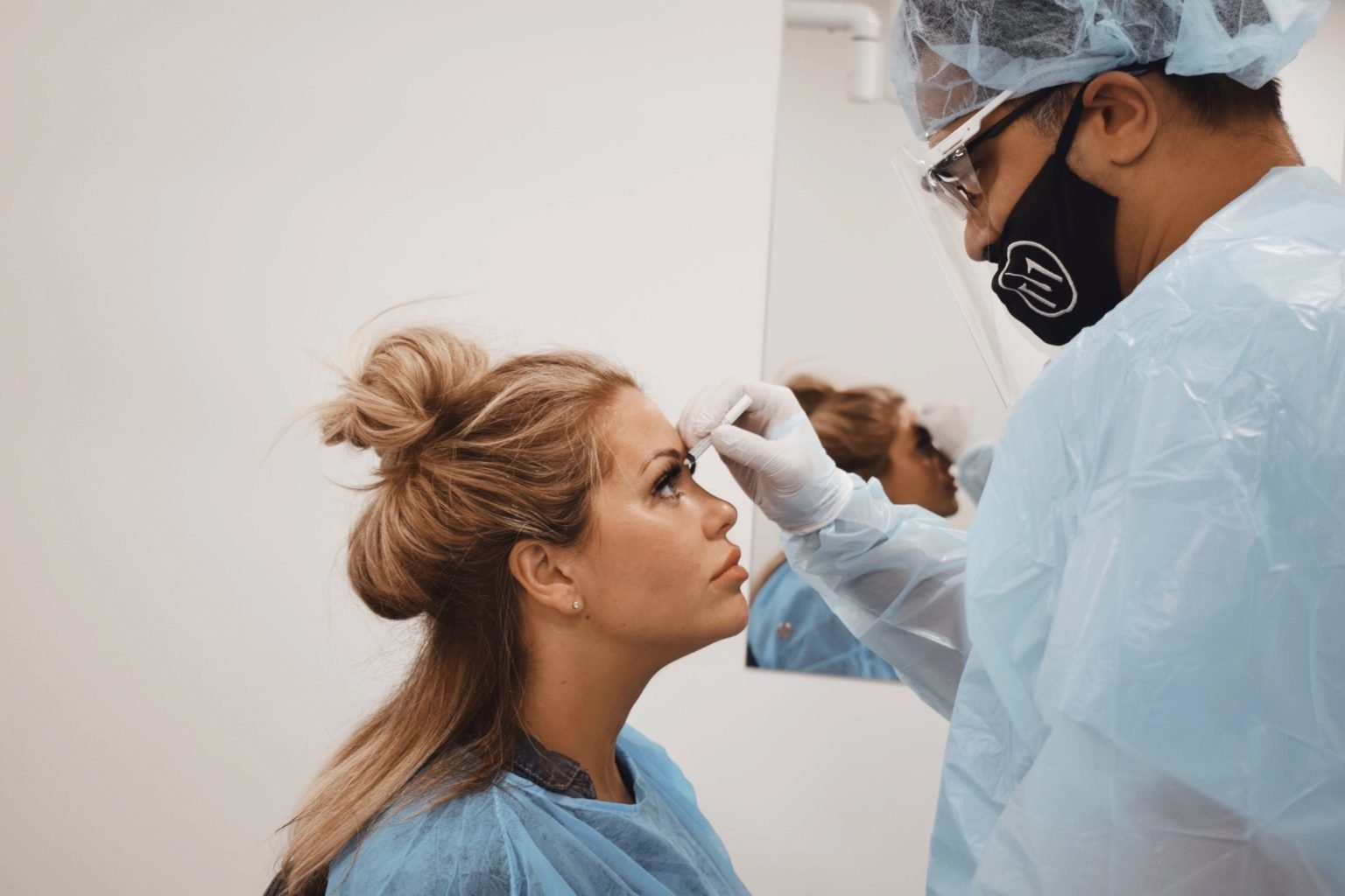 Dr Matee marking an eyebrow transplant design